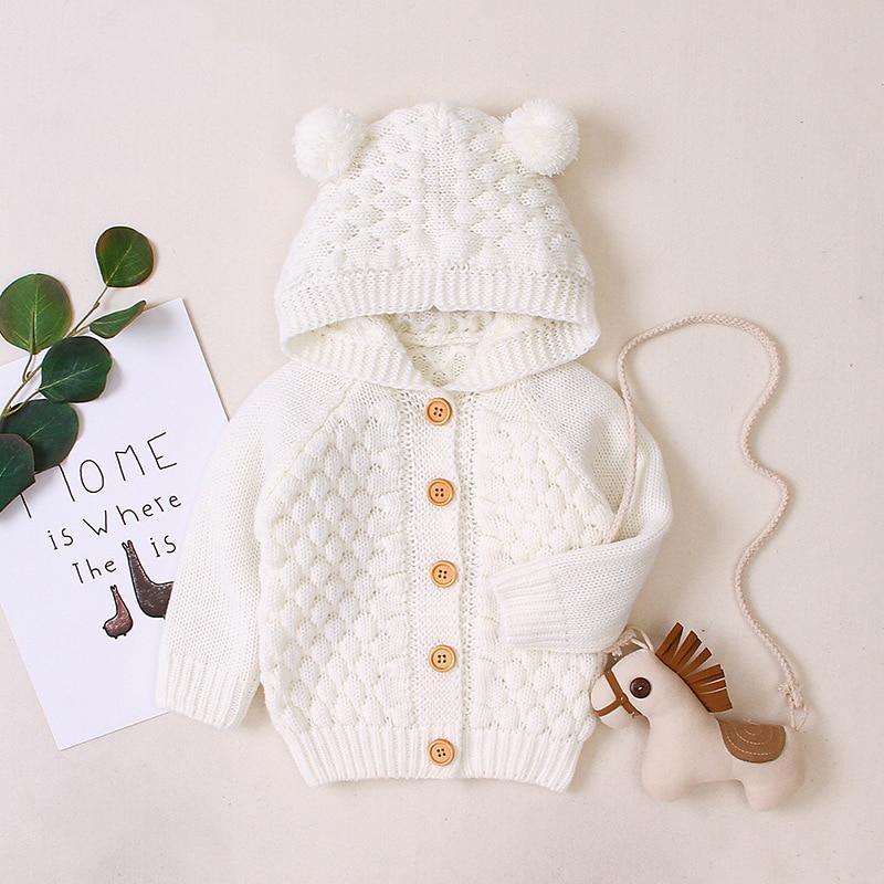 Infant hooded knit jacket, white, pom-pom hood, textured pattern, button front