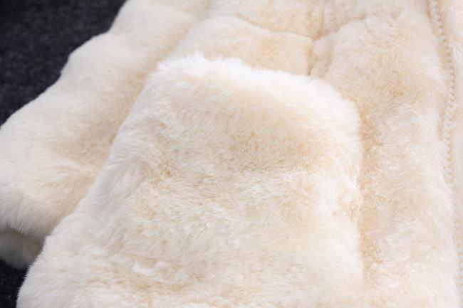 Cream white plush jacket close-up, soft sherpa fabric with quilted texture