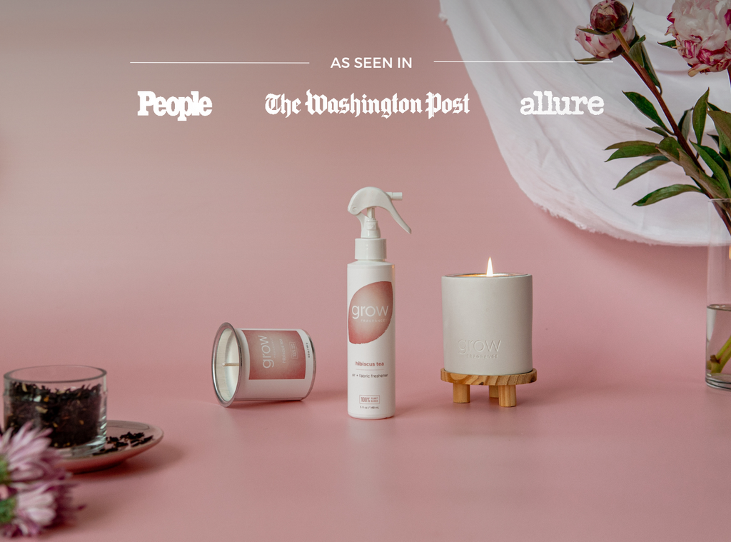Hibiscus tea air and fabric spray bottle with white sprayer, with candle nearby