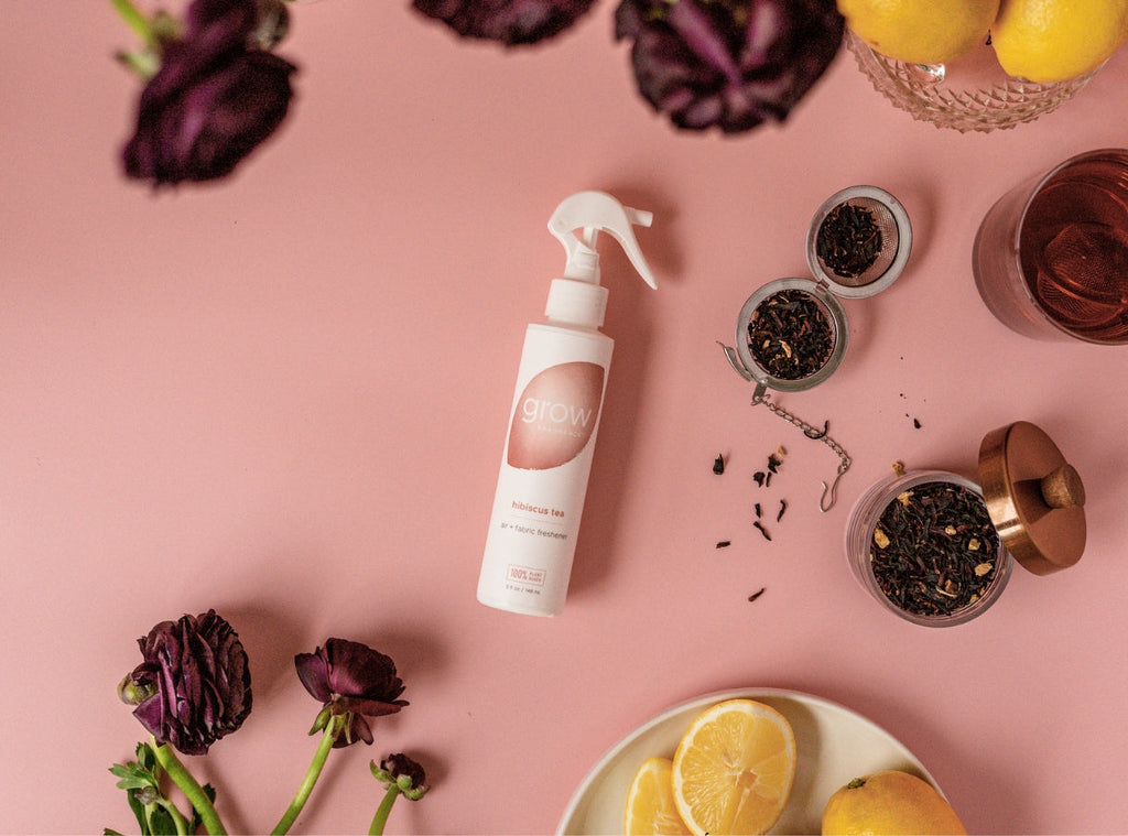 Hibiscus tea air and fabric spray bottle with white sprayer, among dried tea