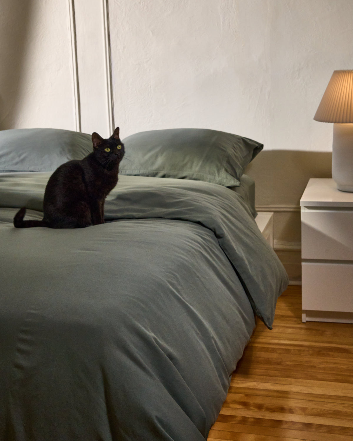 Highlands green milk-fibre pillowcase set on bed, two pillowcases visible
