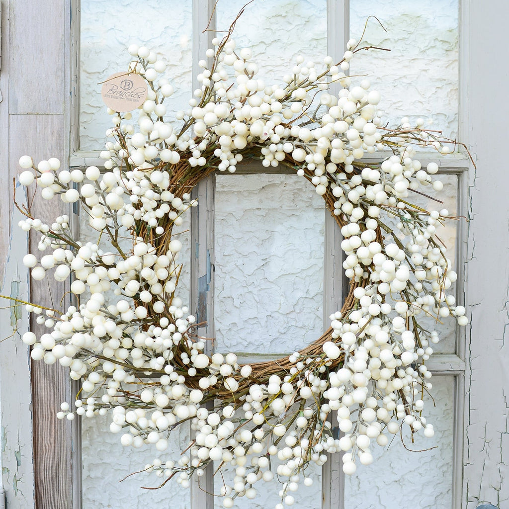 Cream berry wreath with lush white berry clusters and a circular twig frame on a door