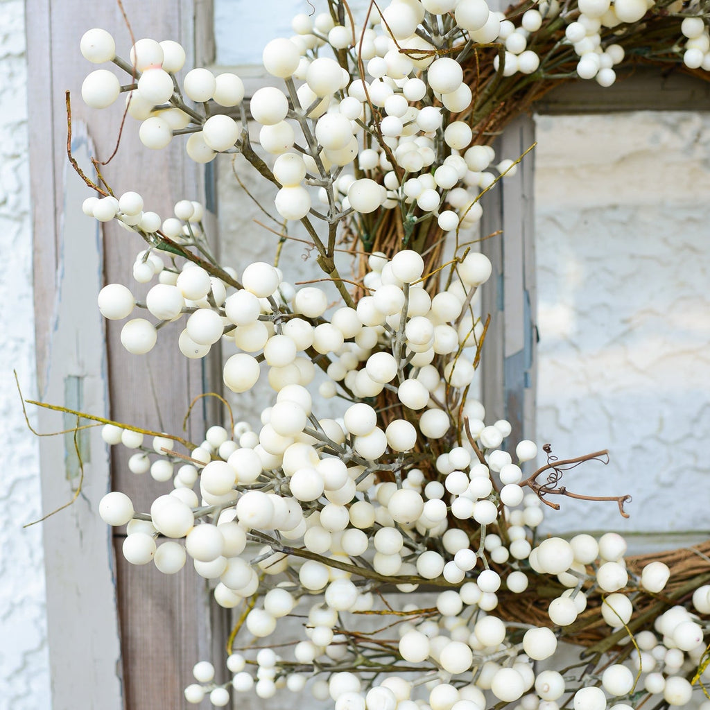 Cream berry wreath close-up with densely packed white bead-like berries and twig stems