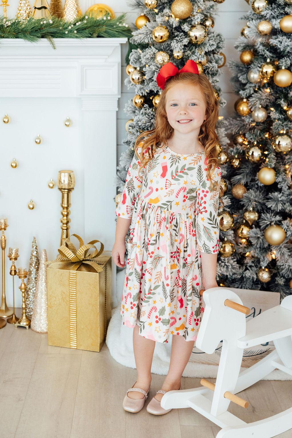 Girls’ 3/4 sleeve twirl dress in white with red, green, and gold holiday print