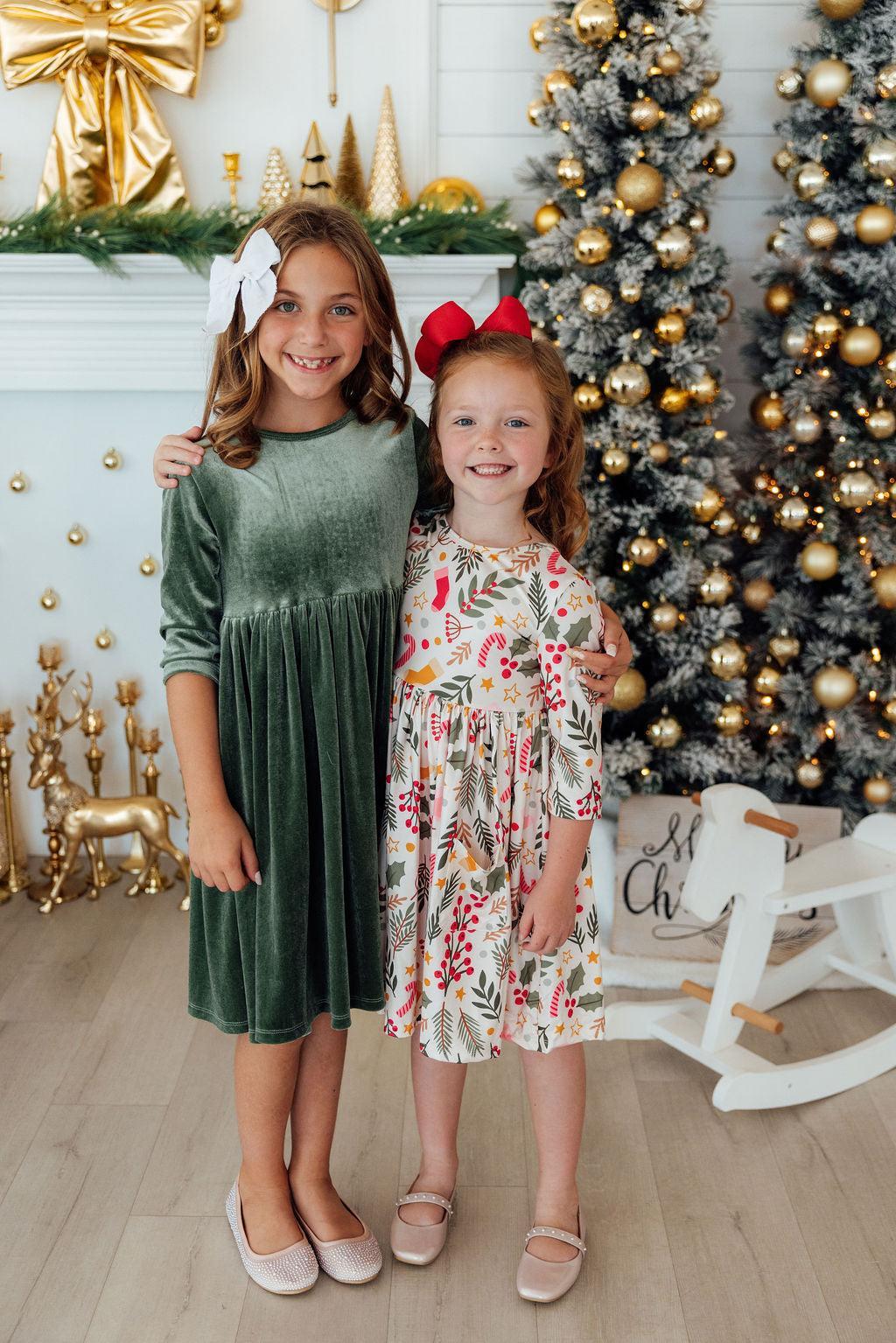 Girls’ 3/4 sleeve twirl dress with red bow and festive holly-themed print