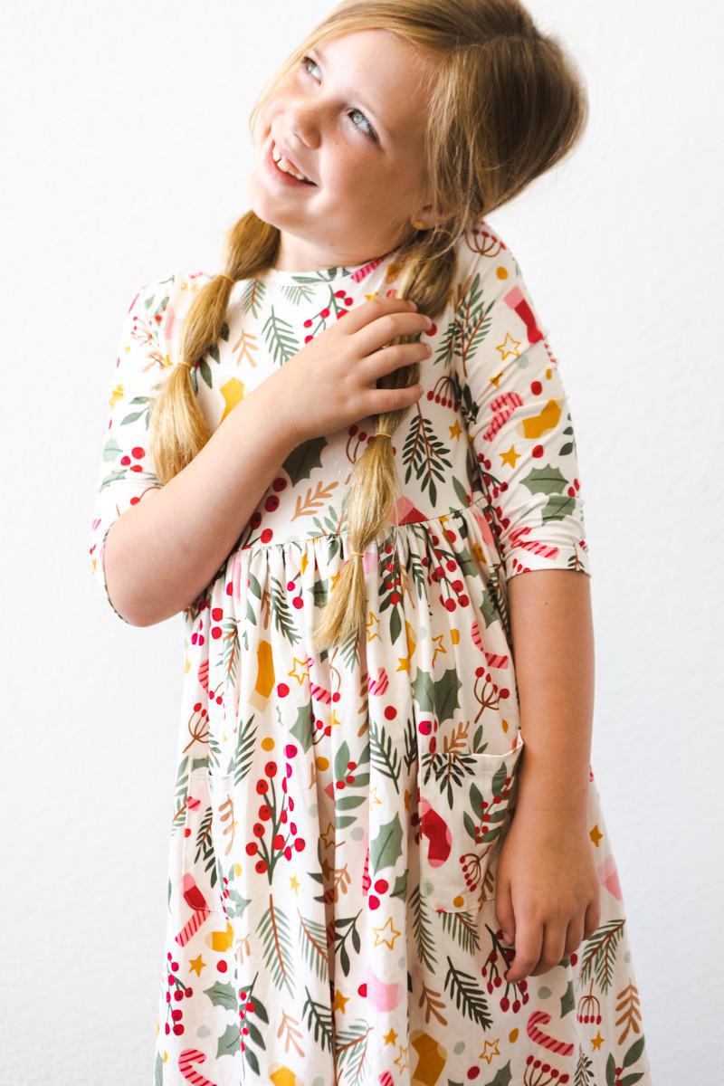 Girls’ 3/4 sleeve twirl dress with festive red, green, and gold scattered print