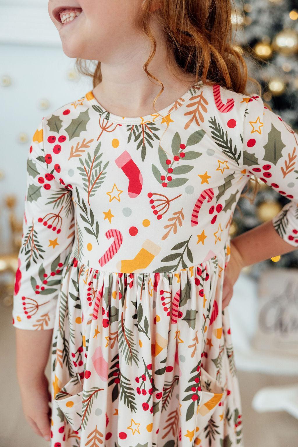 Girls’ 3/4 sleeve twirl dress with festive red, green, and gold print