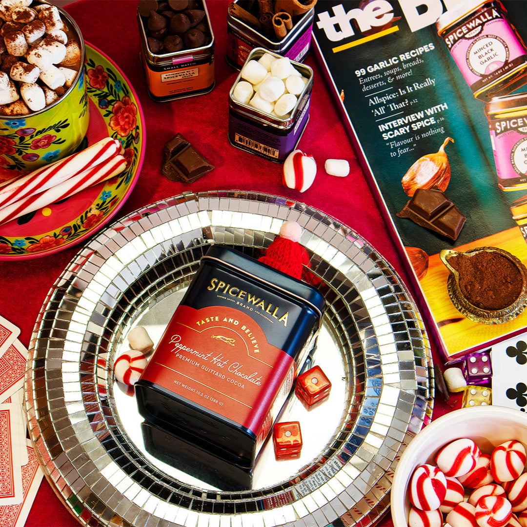 Spicewalla Peppermint Hot Chocolate Deluxe tin in center of holiday snack platter