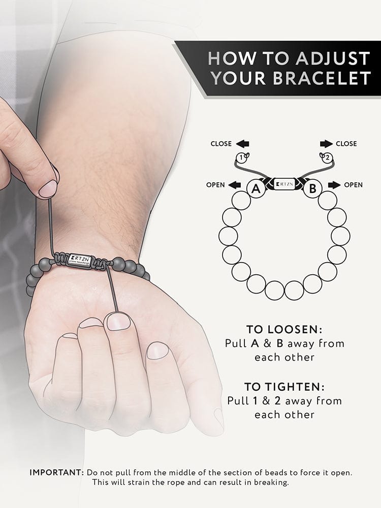 Black beaded bracelet on wrist being adjusted, showing cord loop and knot