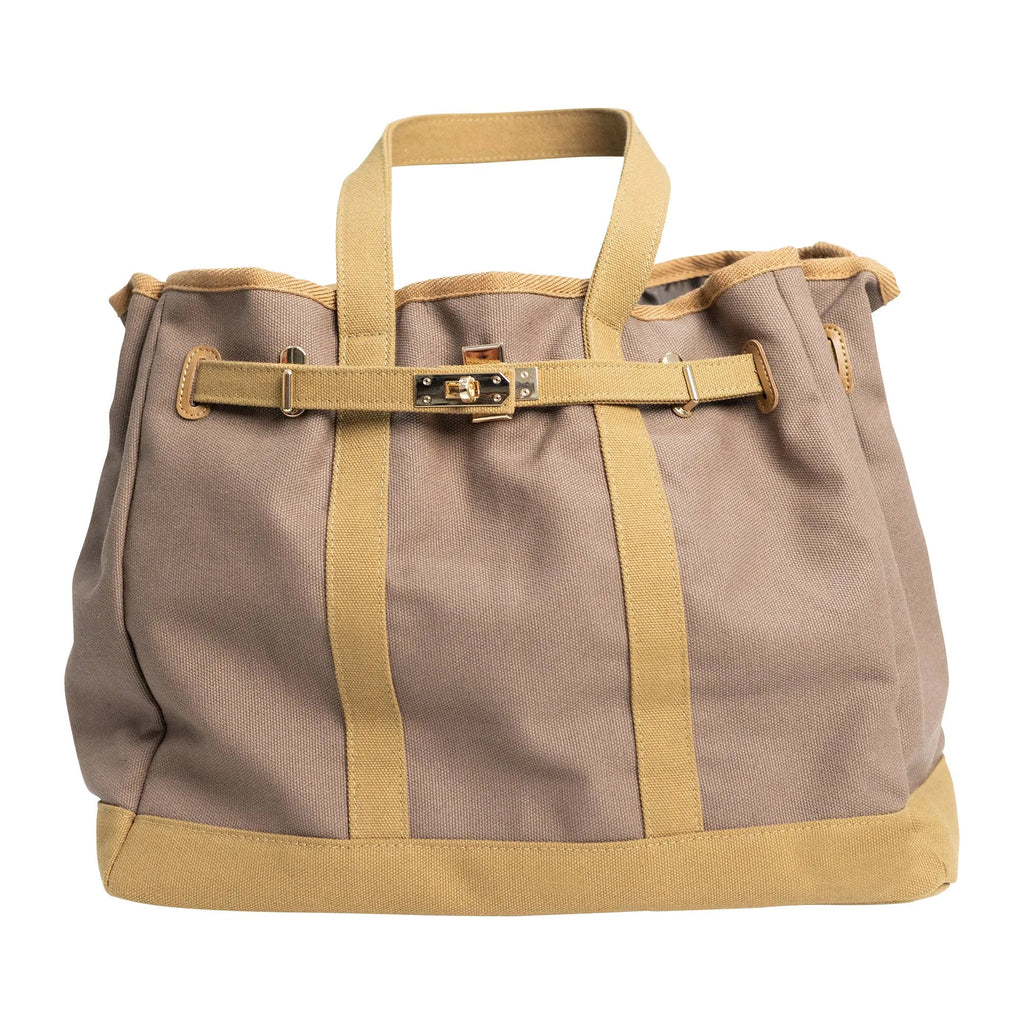 Tan canvas tote bag with tan straps, front buckle, and gold-tone hardware