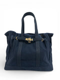 Navy canvas tote bag with gold hardware, short handles and front clasp