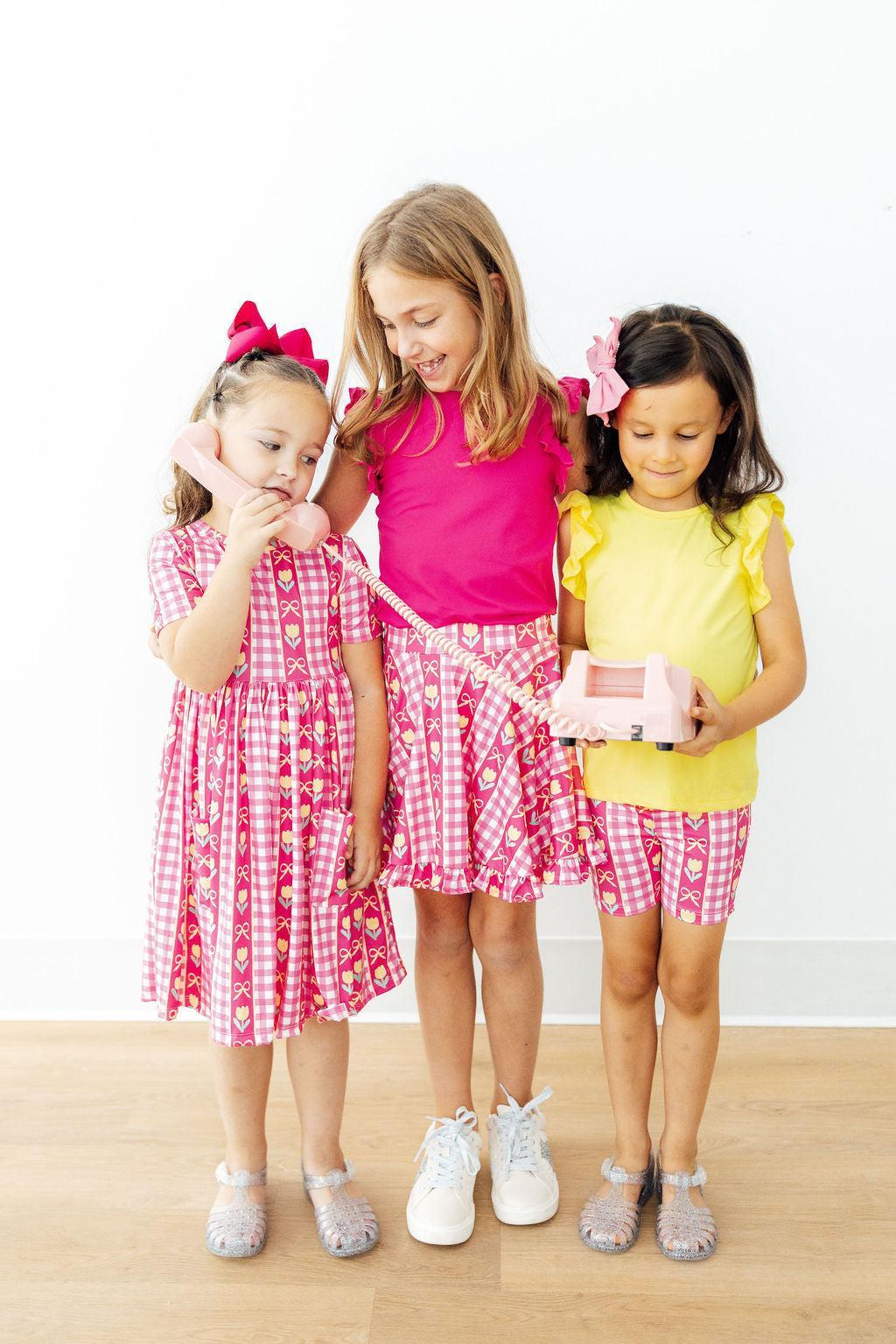 Pink ruffle skort with heart-and-tulip check print and twirl skirt flare, elastic waist