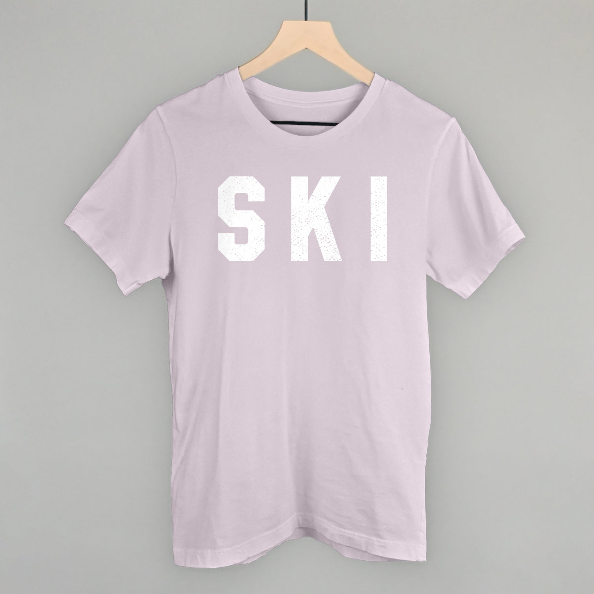 Ski Collegiate light pink short-sleeve tee with large white “SKI” graphic