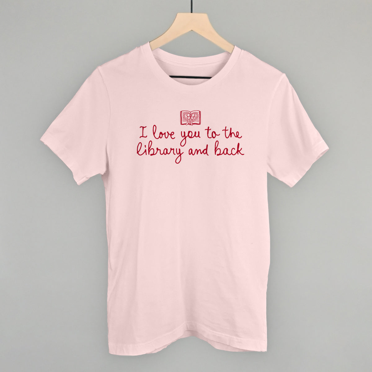 Soft pink short-sleeve T-shirt with red "I love you to the library and back" graphic