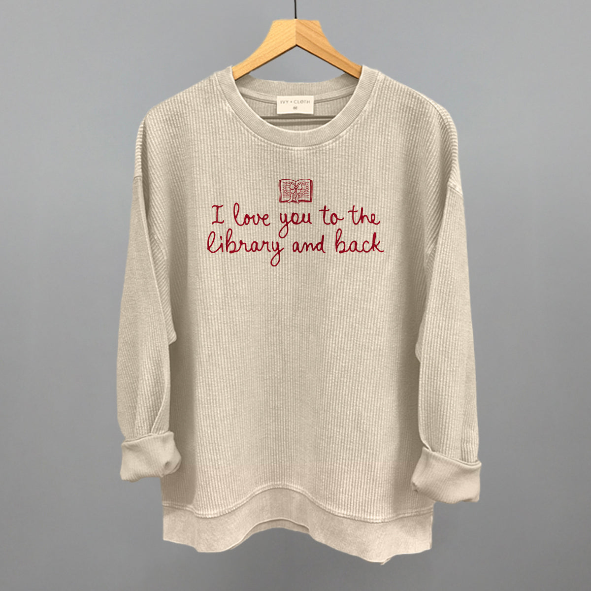 Oatmeal waffle-knit sweatshirt with red "I love you to the library and back" graphic