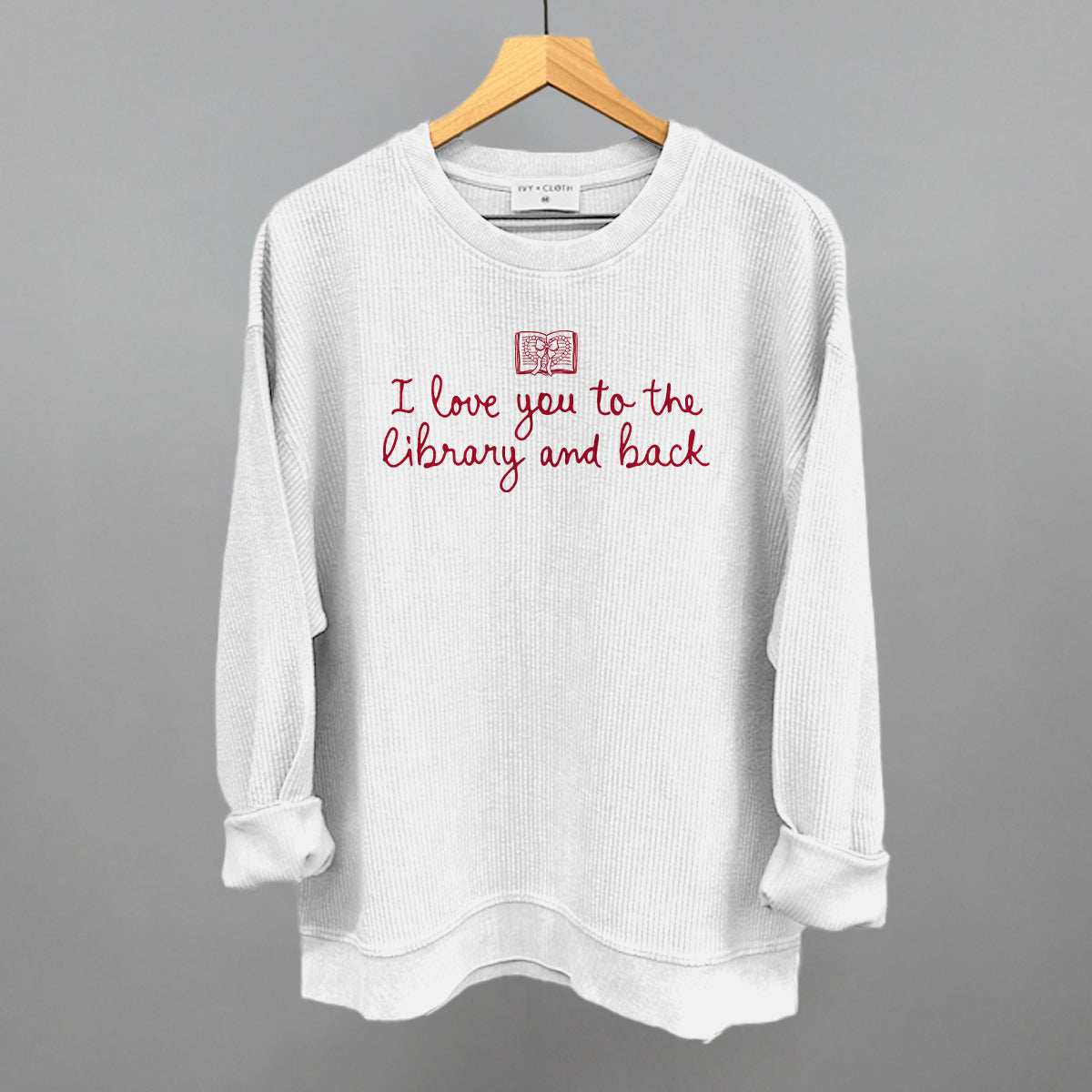 Ivory waffle-knit sweatshirt with red "I love you to the library and back" graphic