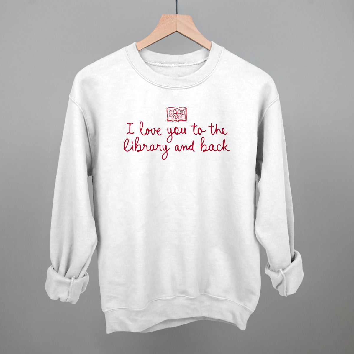 White crewneck sweatshirt with library-and-back text graphic