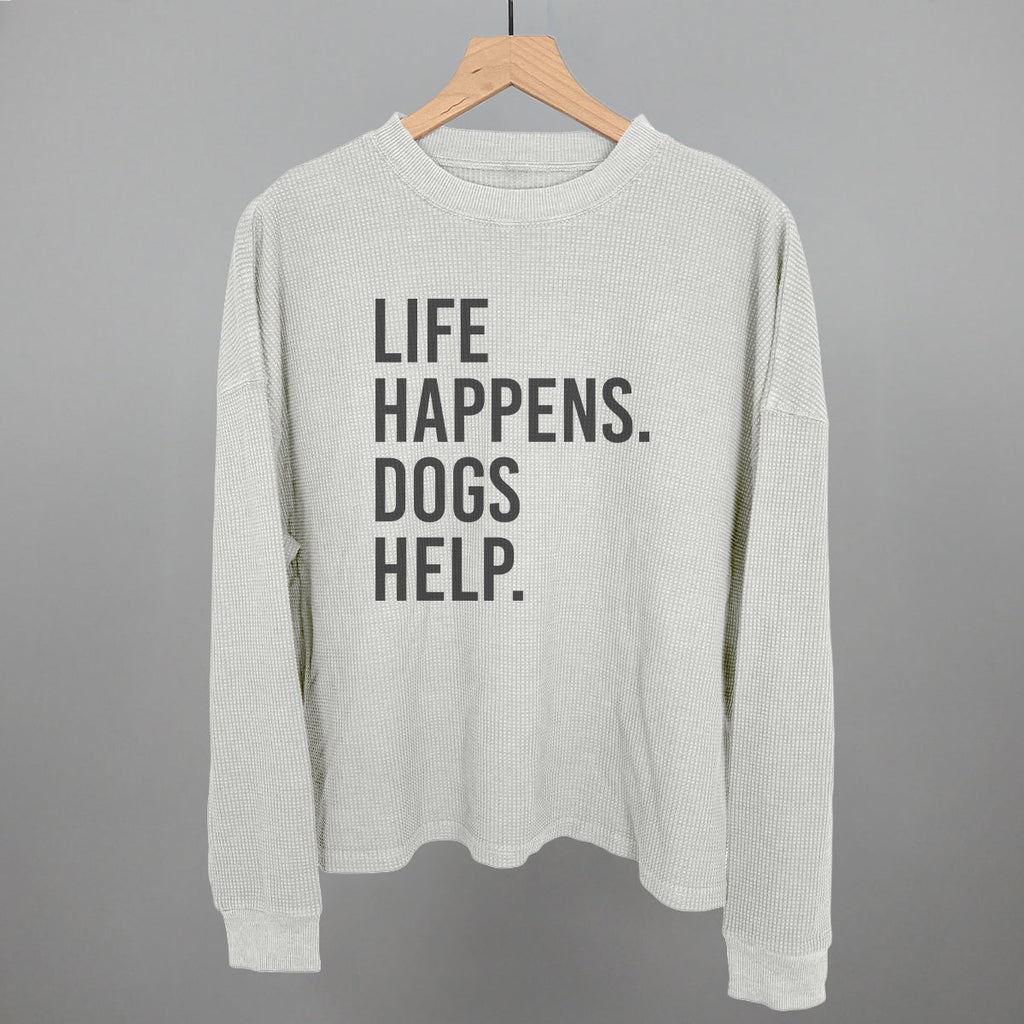 White waffle-knit crewneck sweatshirt with centered 'LIFE HAPPENS. DOGS HELP.' graphic