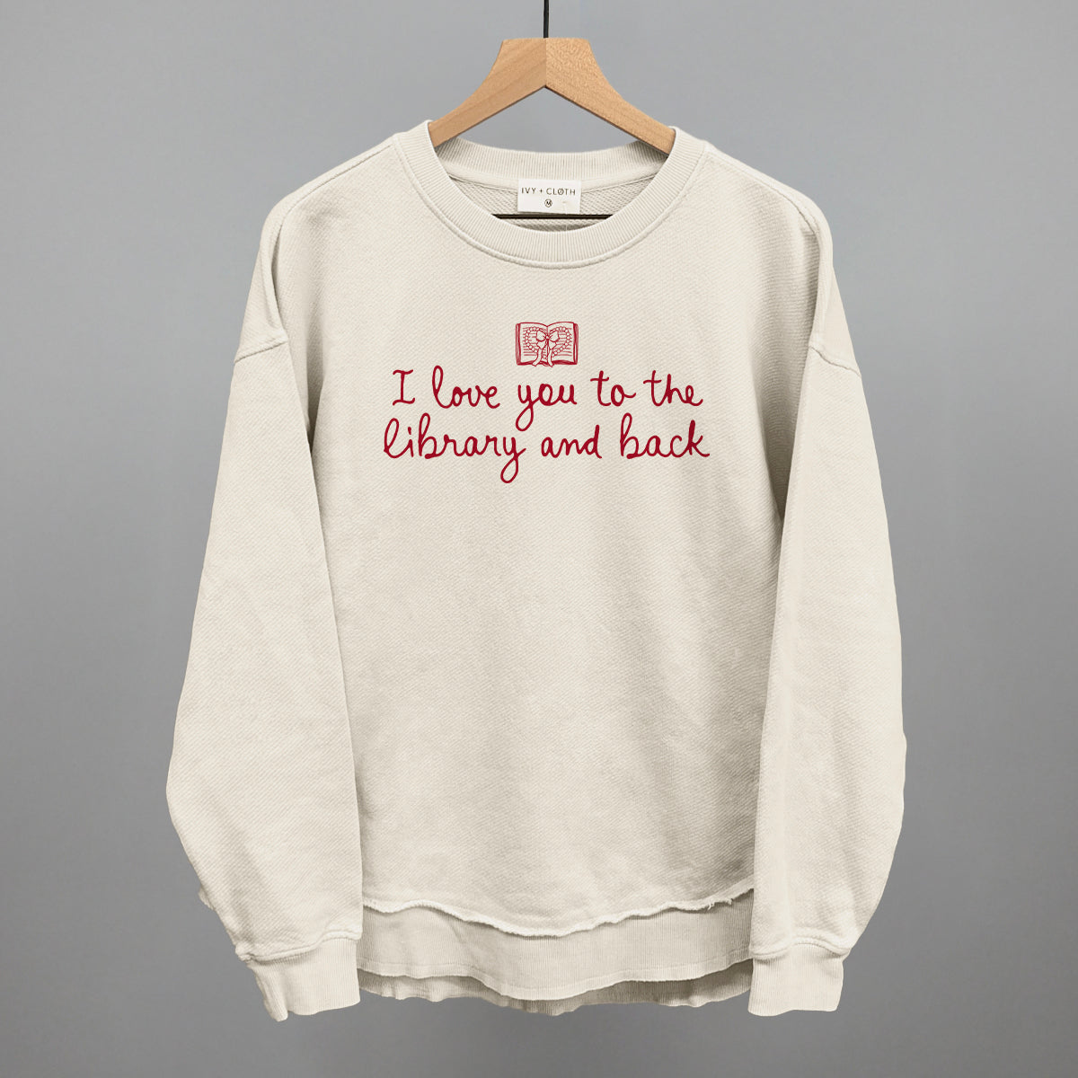 Cream sweatshirt with red "I love you to the library and back" graphic