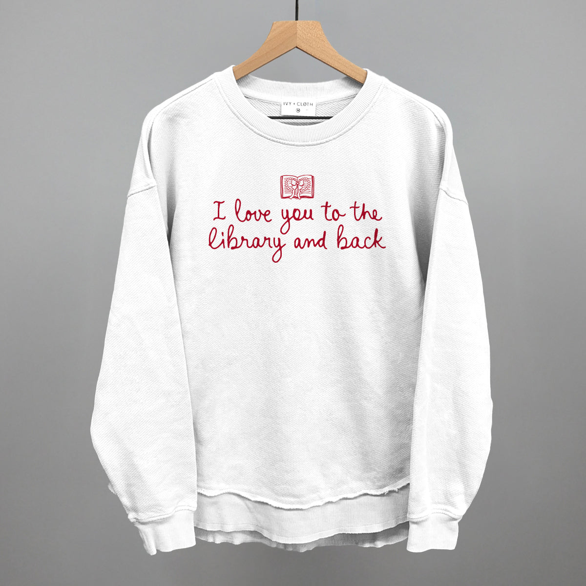 White crewneck sweatshirt with red "I love you to the library and back" graphic