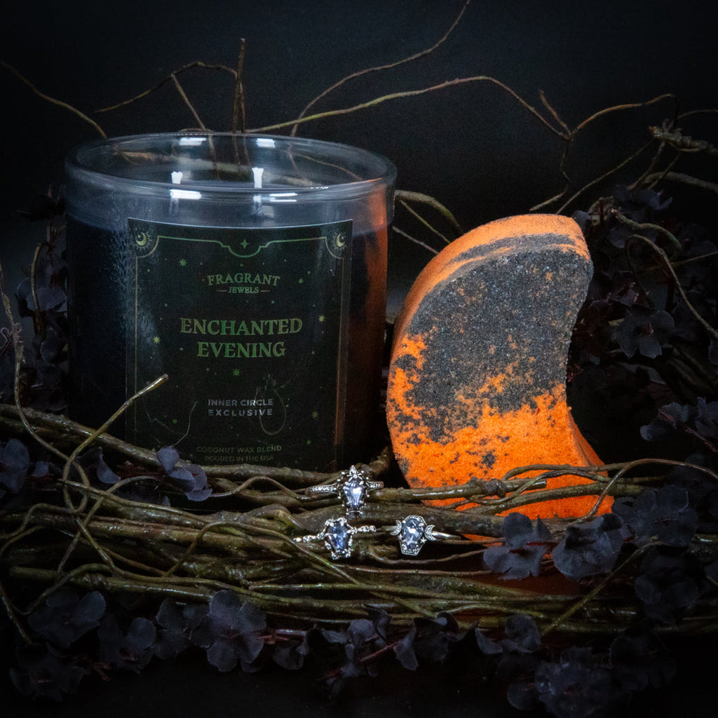 Candle jar, orange bath bomb, and rhodium-plated sterling silver rings on dried stems
