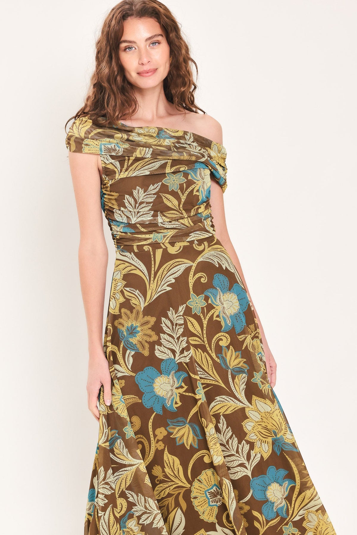 Brown and teal floral one-shoulder mesh midi dress with off-shoulder drape and flared skirt.