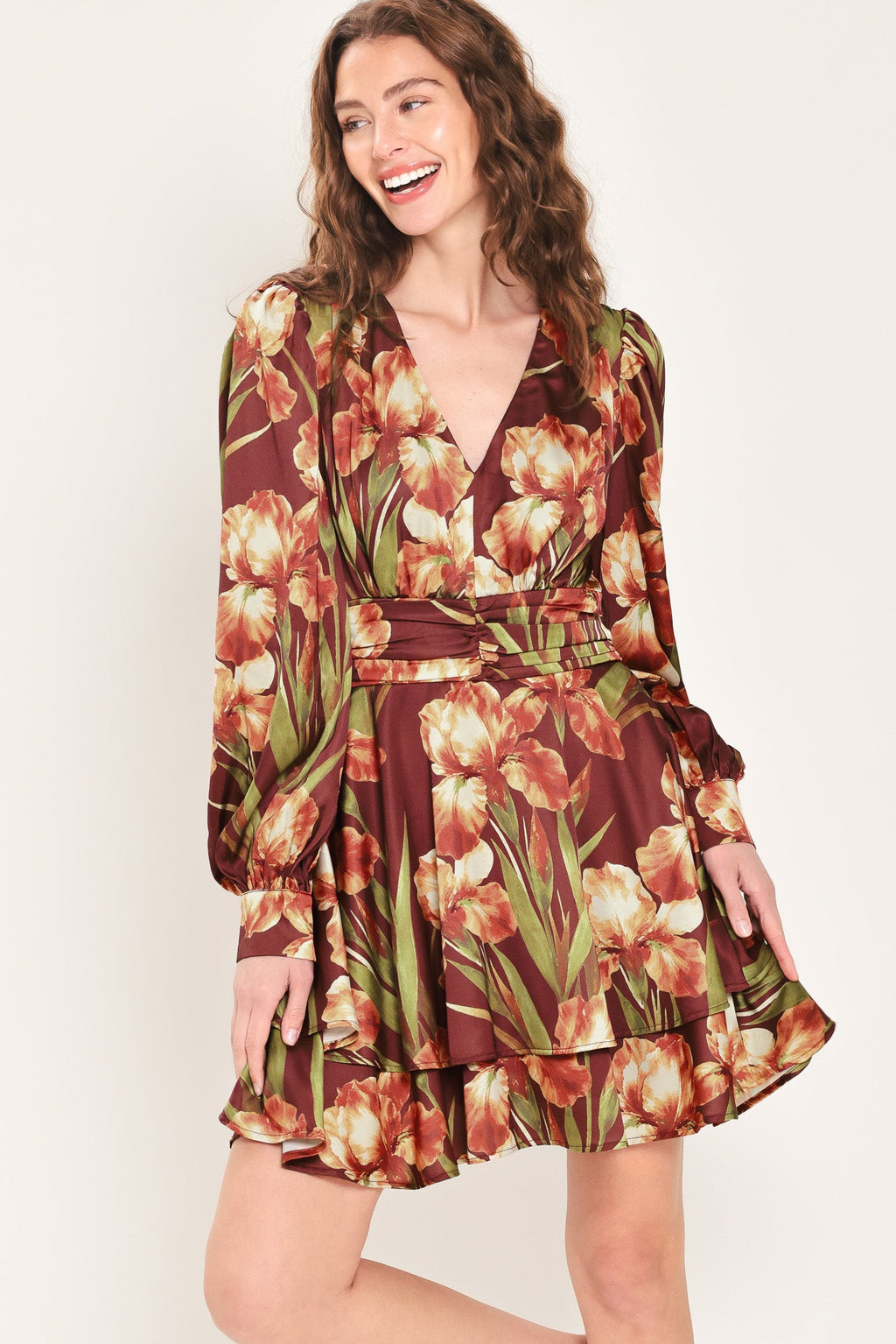 Floral mini dress with V-neck, ruched waist belt, tiered hem, long puff sleeves.