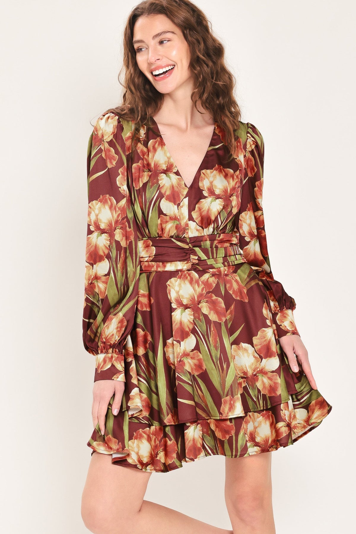 Floral mini dress with V-neck, ruched waist belt, tiered hem, long puff sleeves.