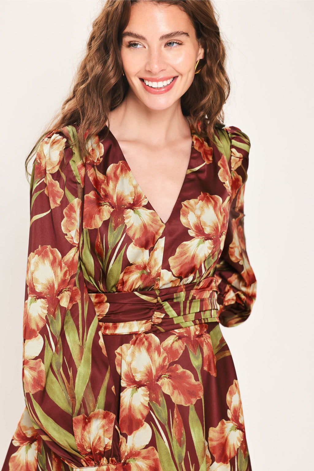 Floral mini dress with V-neck and ruched waist belt, long puff sleeves, close-up.