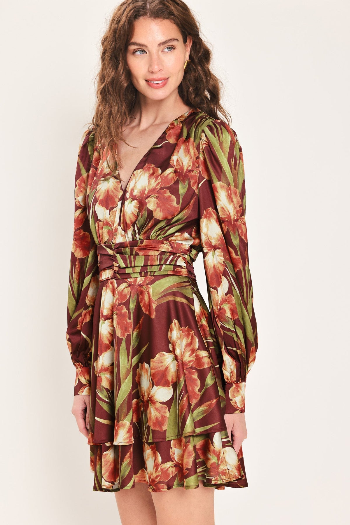 Floral mini dress with V-neck, ruched waist belt, long puff sleeves, tiered skirt.