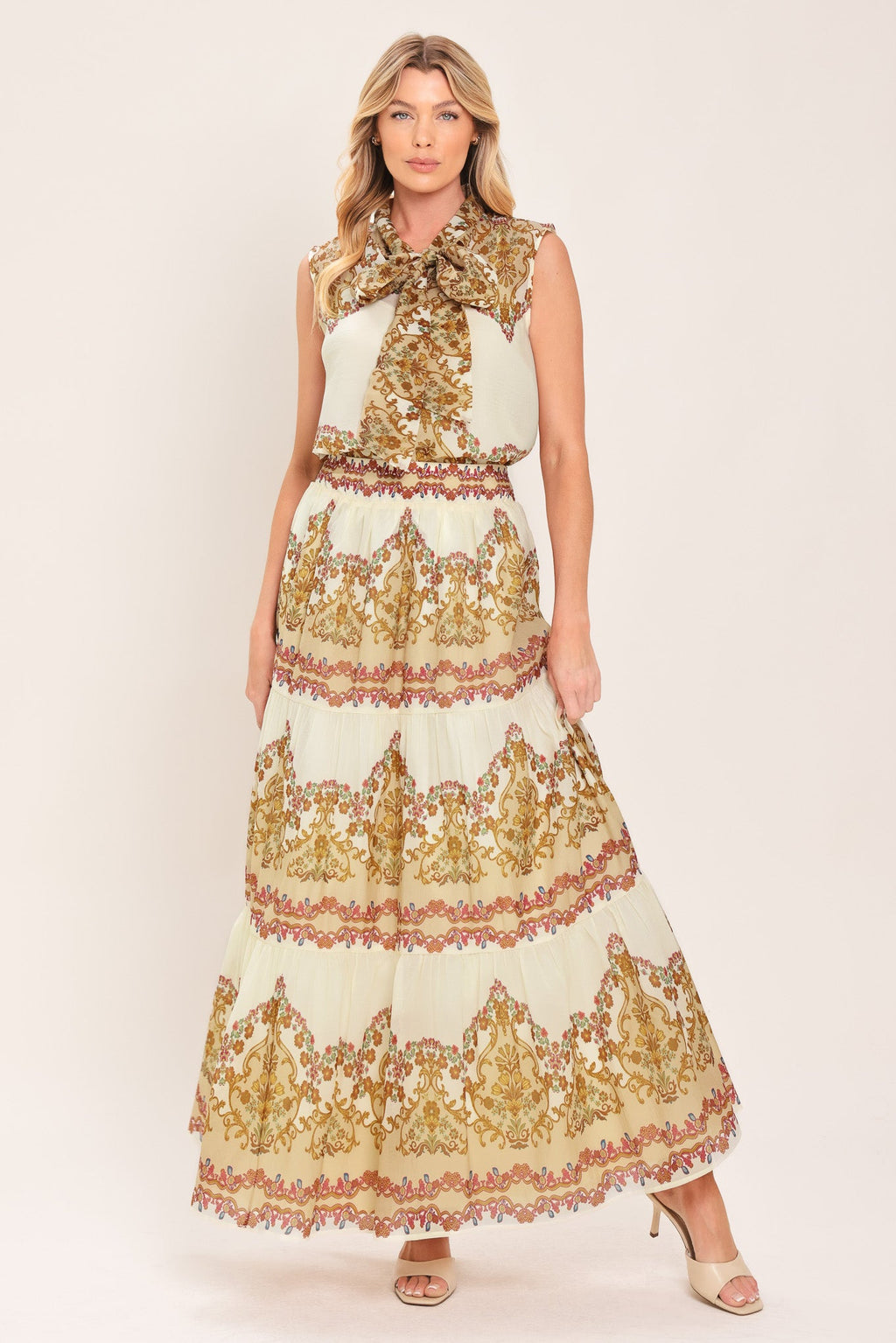 Ivory tiered maxi skirt with gold, red, and green ornate scroll print tiers