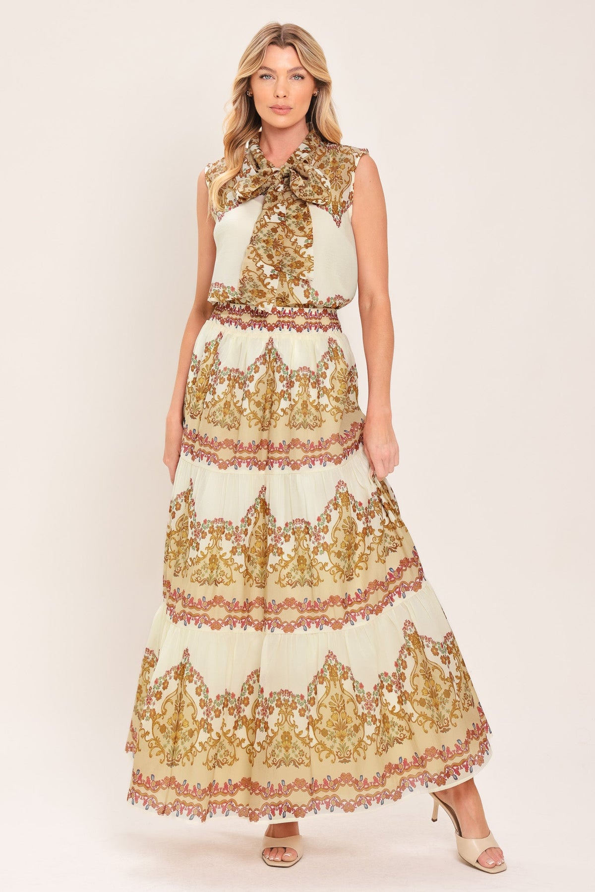 Ivory tiered maxi skirt with gold, red, and green ornate scroll print tiers