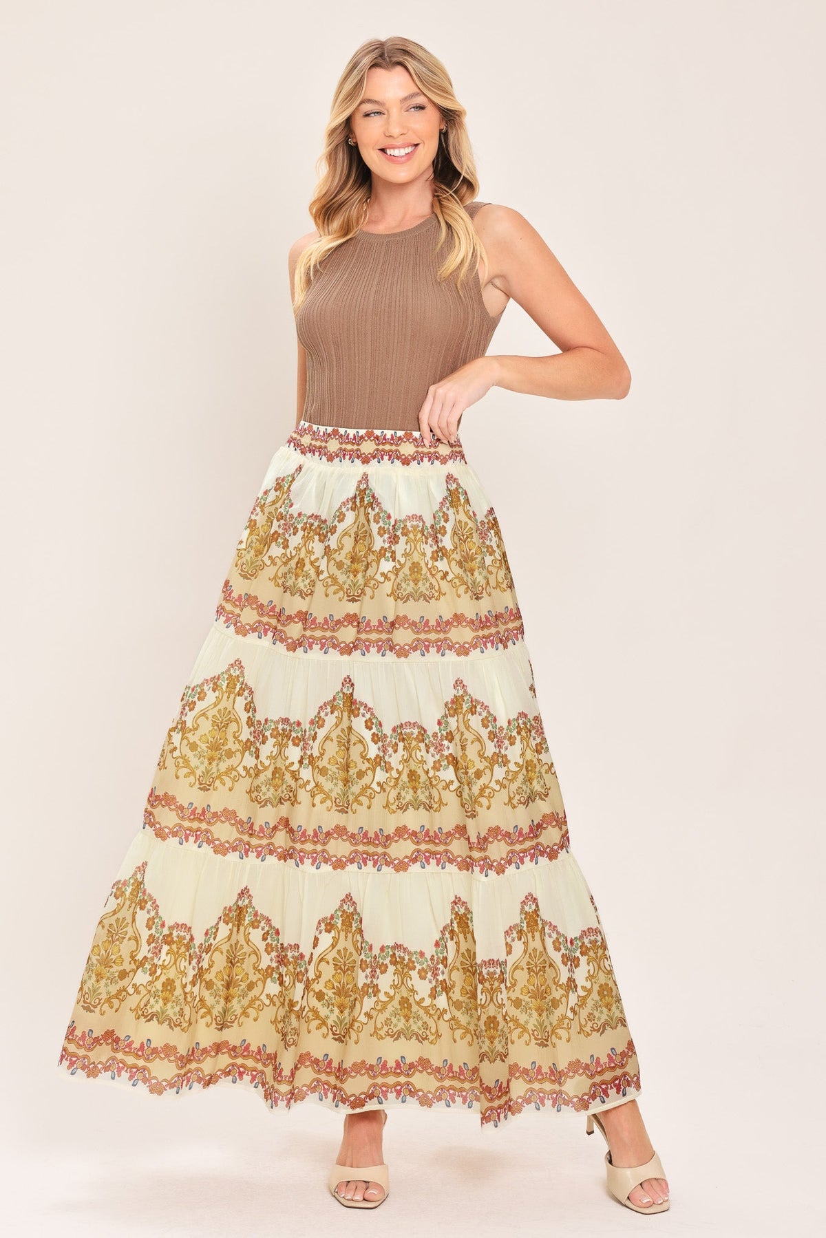 Ivory tiered maxi skirt with gold and red scroll print; elastic waist and layered hem