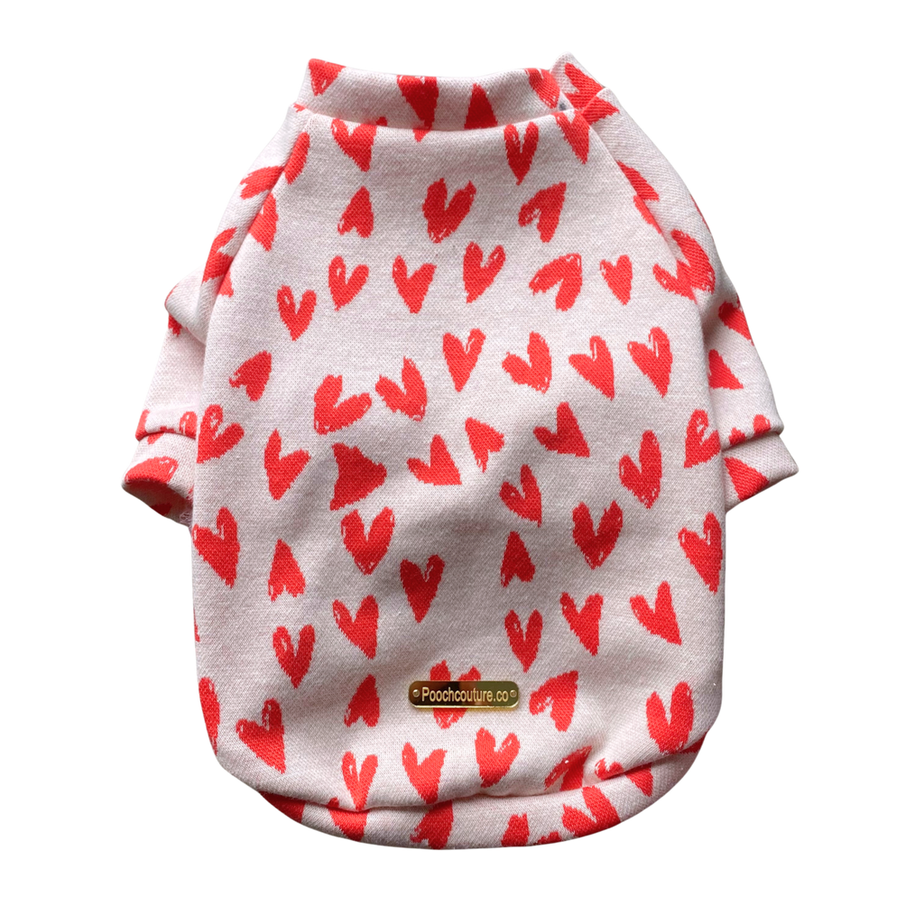 White cotton raglan shirt with red heart print, rounded hem, and red trim at neck