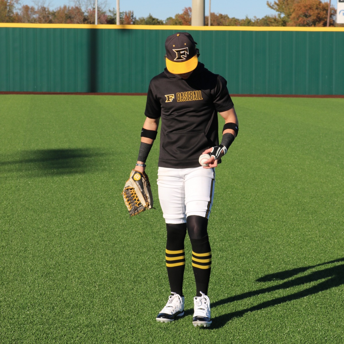 Baseball fielder wearing a glove and holding a white baseball