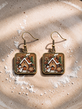 Square dangling gingerbread cottage drop earrings with house, tree, and snowman in brown