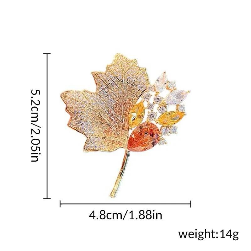 Gold-tone autumn leaf cluster brooch with green, orange, and white crystal accents, pin back
