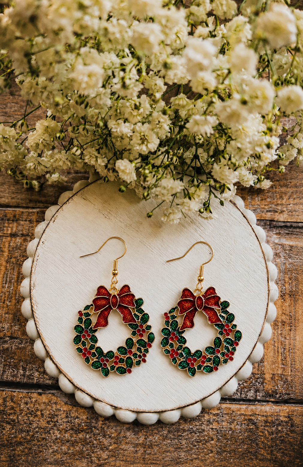 Wreath drop earrings with red berries, green leaves, and gold-tone hooks