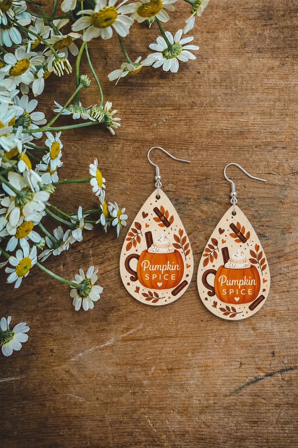Teardrop pumpkin spice earrings with dangling hooks, brown and tan pattern and text
