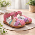 Kids closed-toe sandals in pink with multi-color straps and tan rubber sole