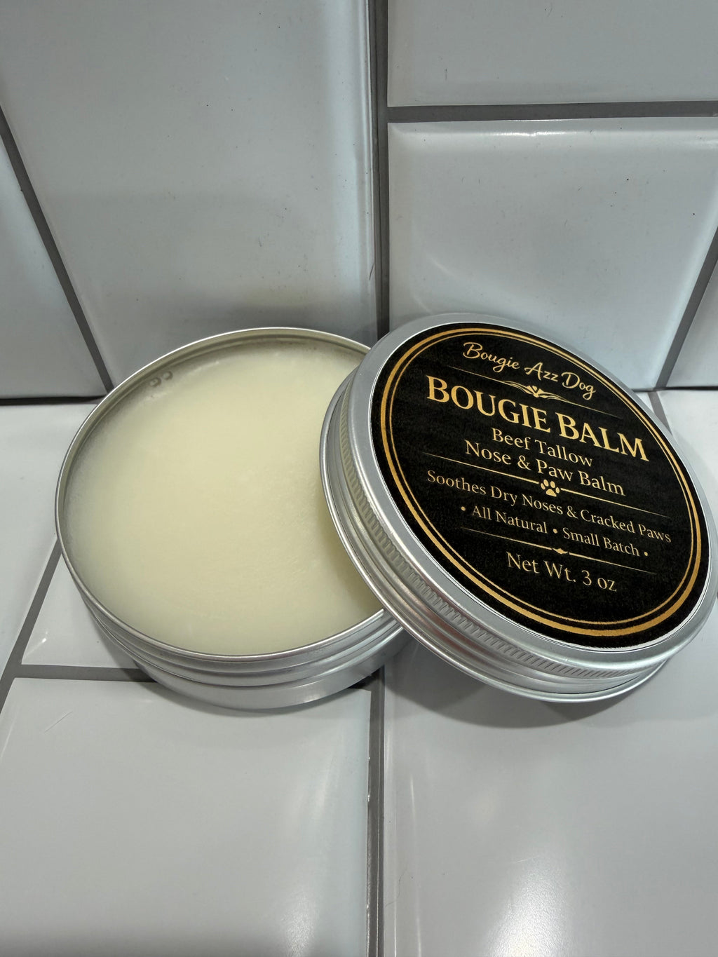 Beef tallow nose & paw balm tin with open lid, white balm inside
