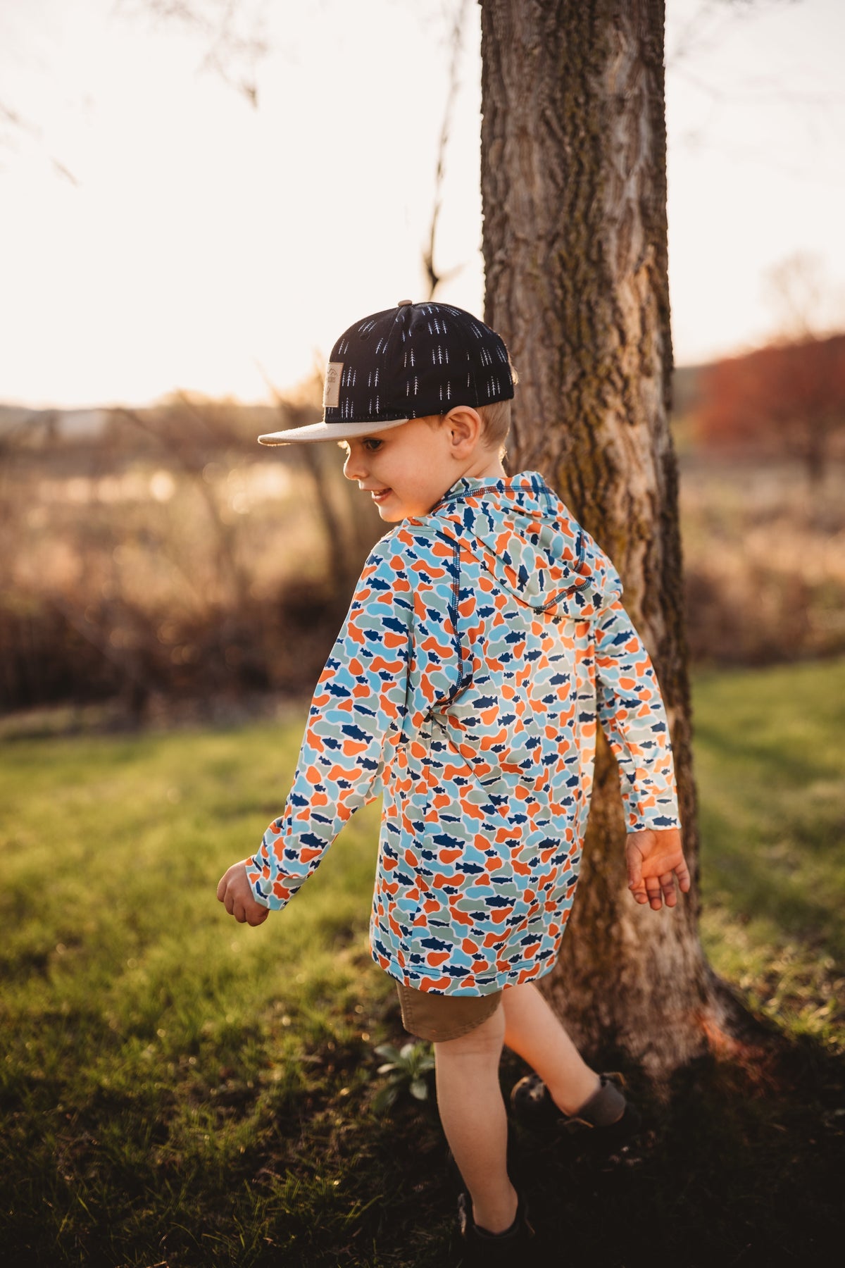 Kids hooded UV cover-up with fish-camo print, long sleeves, side view