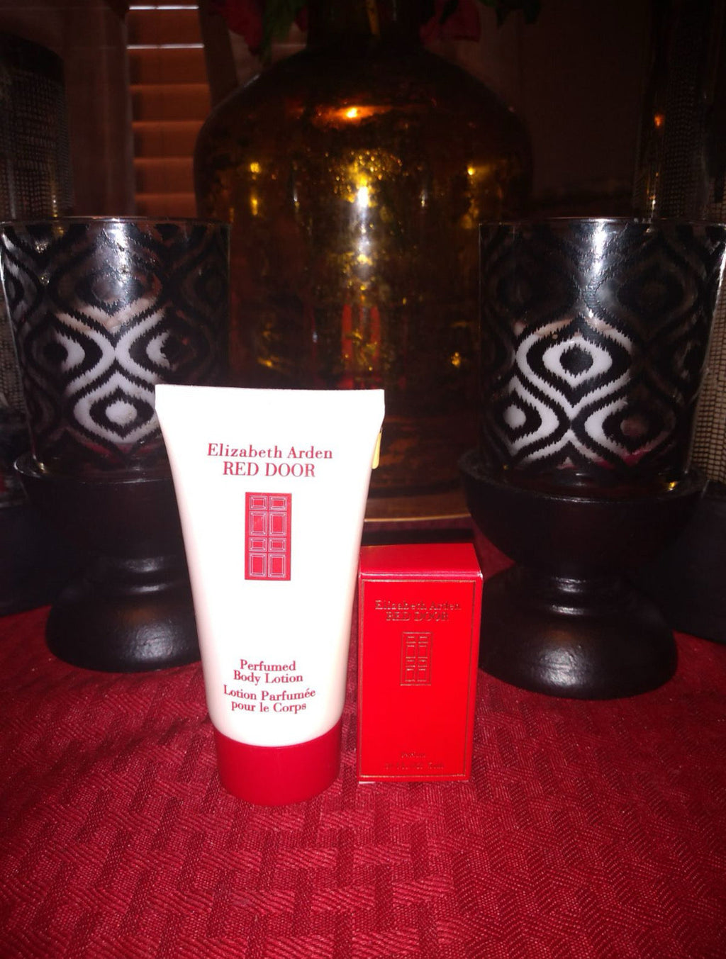Perfume set display: lotion tube, mini fragrance bottle, and red presentation box