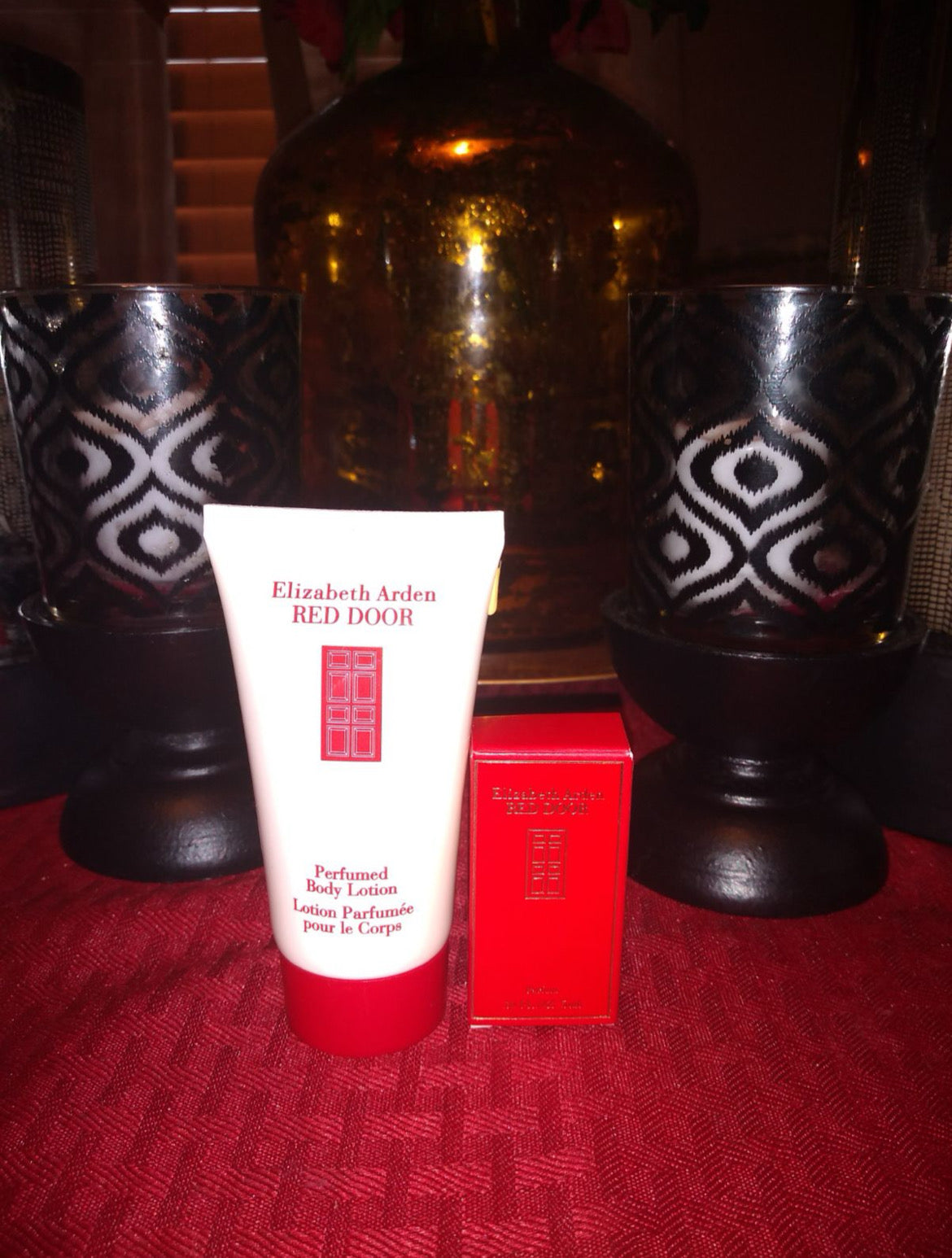 Perfume set display: lotion tube, mini fragrance bottle, and red presentation box