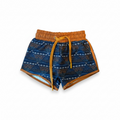 Blue patterned drawstring shorts with orange elastic waistband and tan side trim