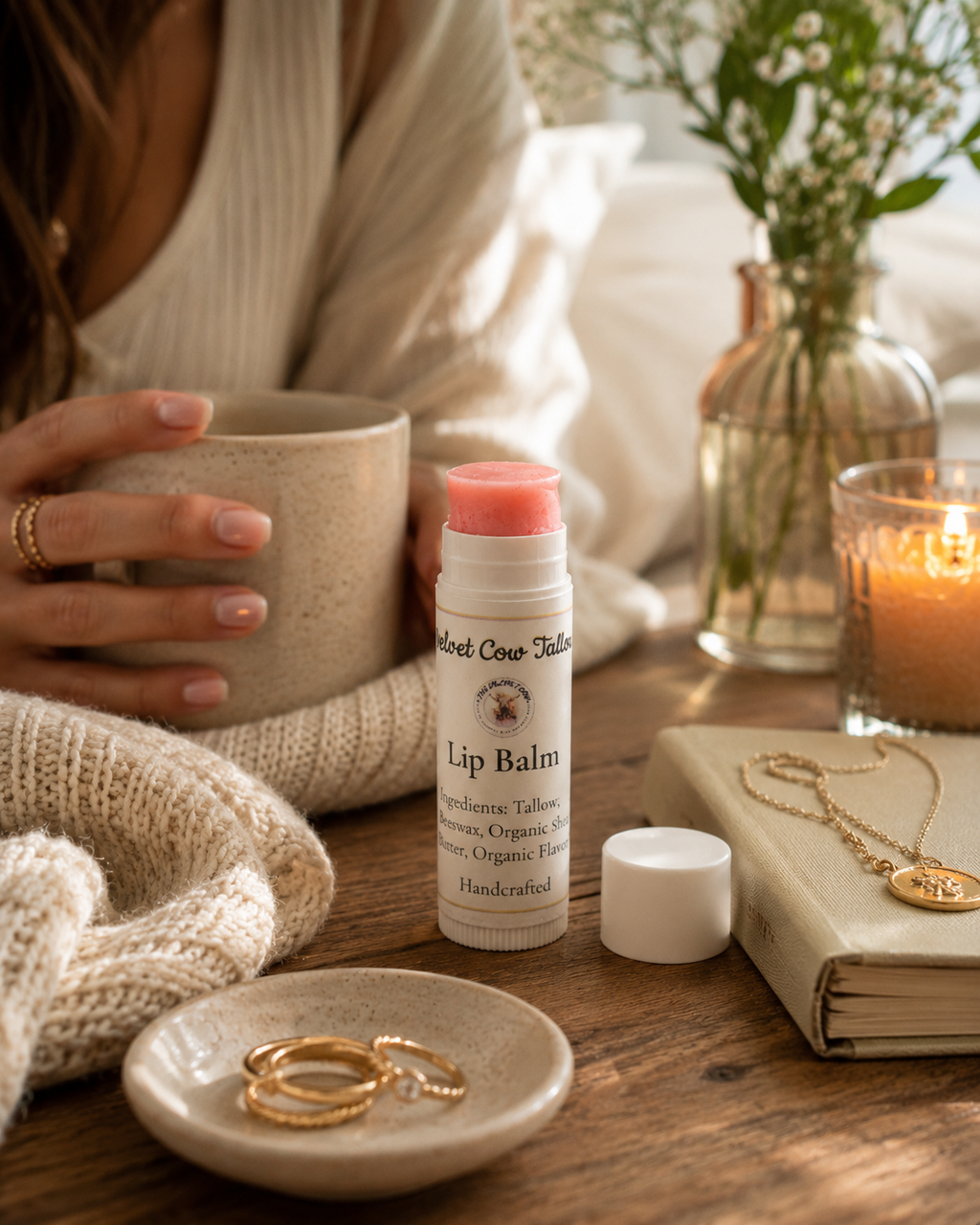 Lip balm stick tube on a table with a second open balm cap nearby