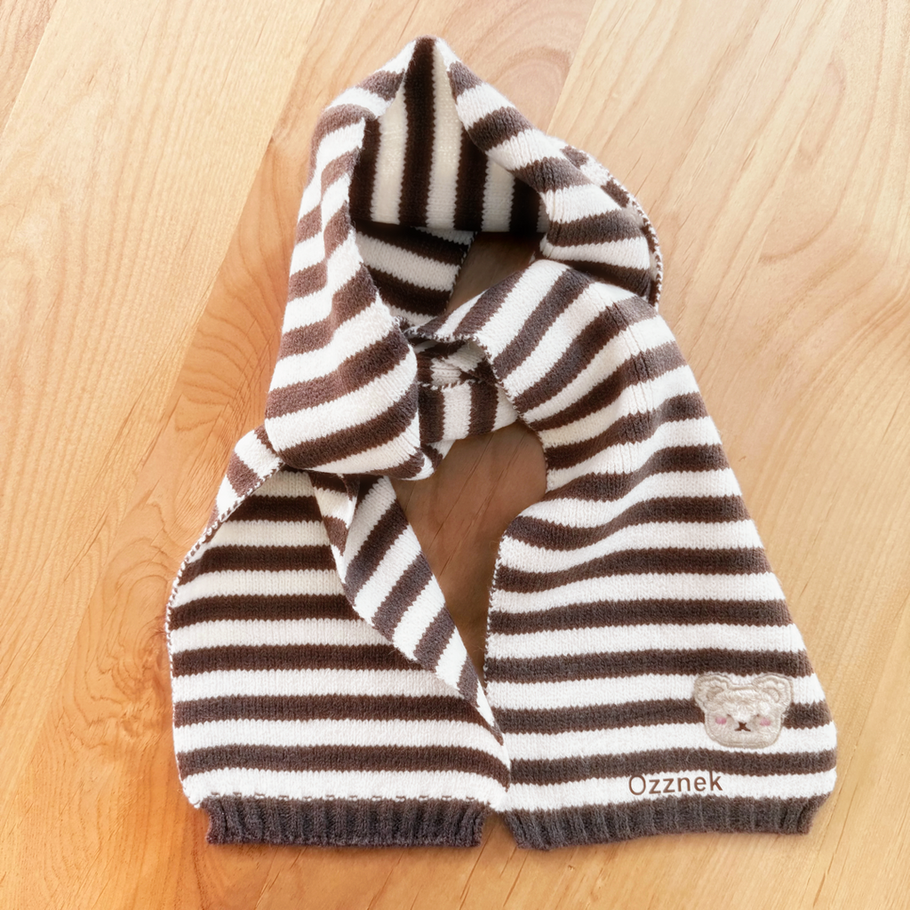 Striped toddler scarf in brown and white knit, bear patch on corner