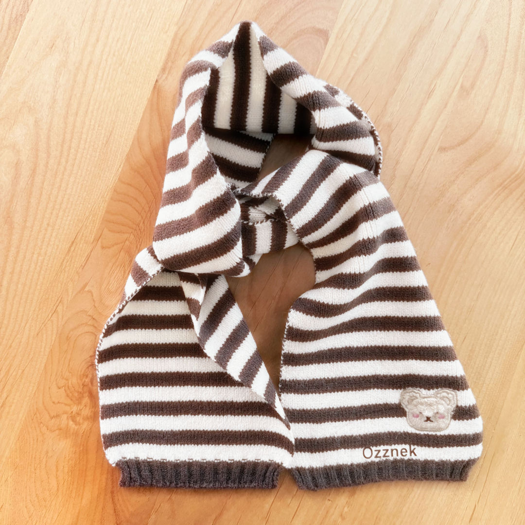 Striped toddler scarf in brown and white knit, bear patch on corner