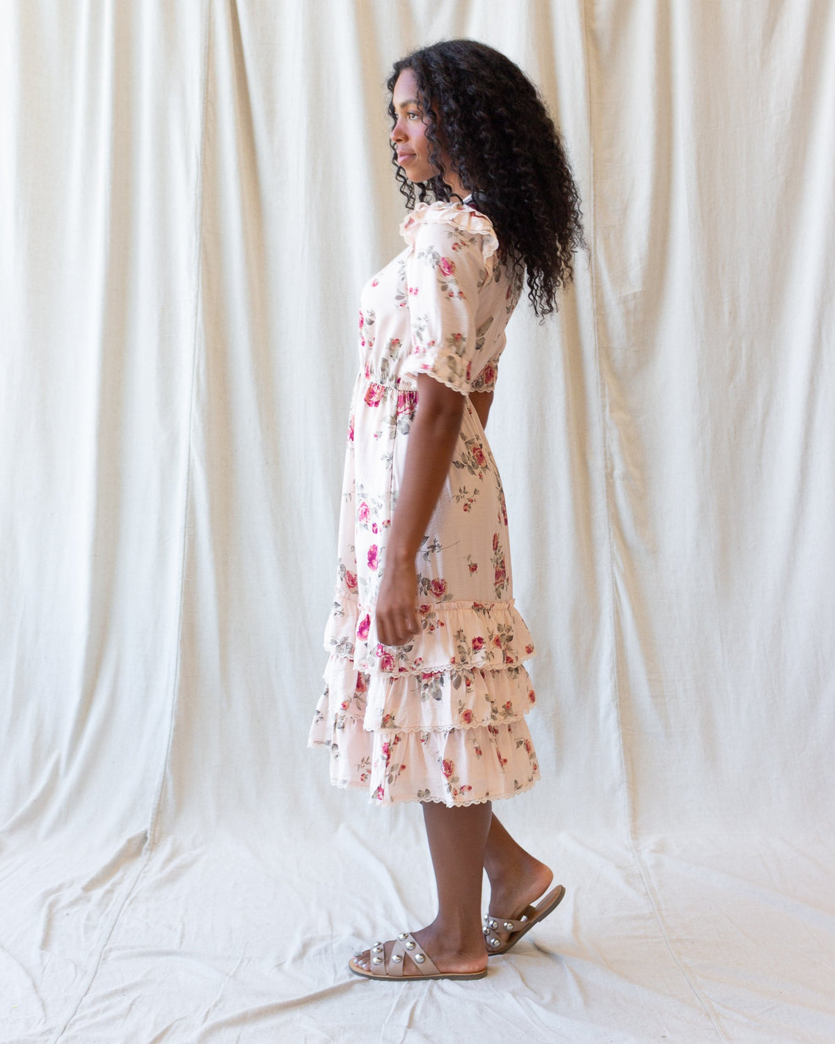Floral tiered mini dress with short puff sleeves and lace-edged ruffles, cream with red blooms