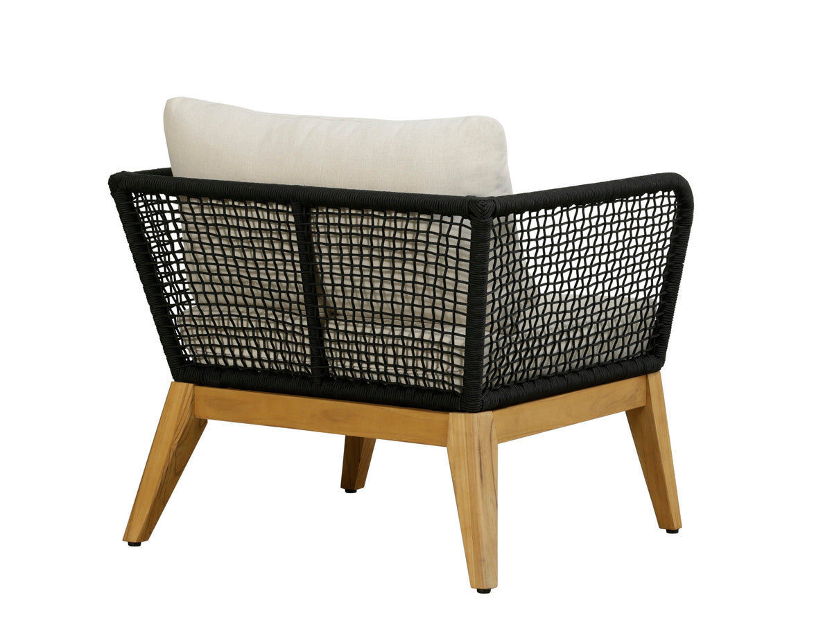 Outdoor arm chair with black woven rope back, white cushion, and teak wood legs